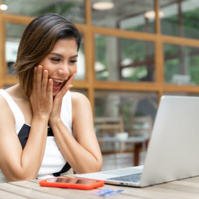 young pretty woman with feeling excitement at cafe